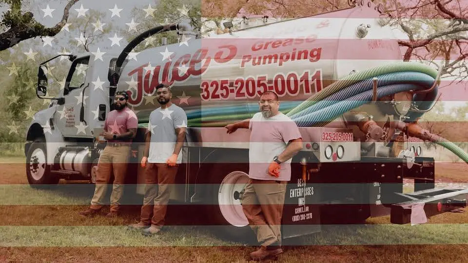 Juice’s Septic crew standing beside the branded company pump truck