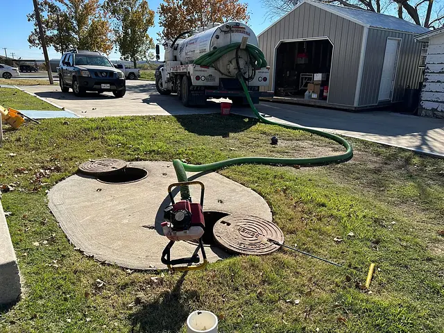 Juice’s Septic pump truck and equipment working at a septic tank